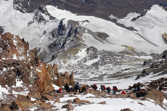 Looking down the Canaleta on Aconcagua, a line of climbers on loose scree between rock towers