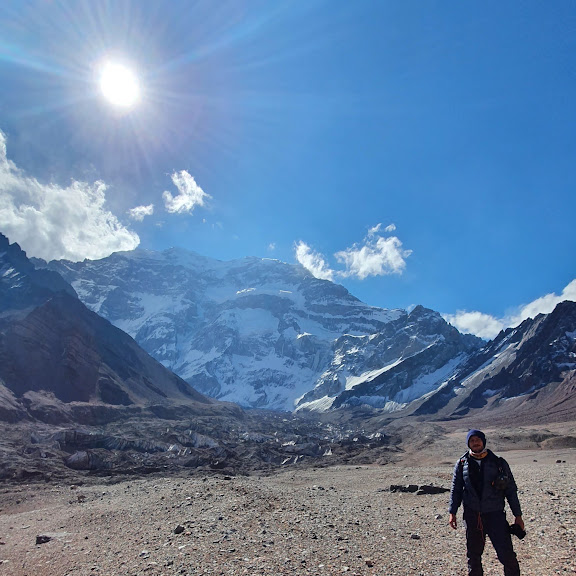 The south face of Aconcagua seen from the Horcones moraine below it, the summit flaring in sun